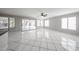 Bright living room featuring white tile flooring, ceiling fan and lots of natural light at 8017 W Eugie Ave, Peoria, AZ 85381
