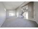 Open living room with neutral carpet, vaulted ceilings, and a staircase leading to the second floor at 8017 W Eugie Ave, Peoria, AZ 85381