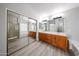 Large main bathroom with glass shower, double sink vanity, and built-in storage closet at 8017 W Eugie Ave, Peoria, AZ 85381