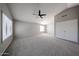 Carpeted main bedroom with high ceilings, a ceiling fan, and bright natural light at 8017 W Eugie Ave, Peoria, AZ 85381