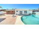 Charming backyard with brick patio, lush landscaping, a refreshing pool, and a cozy fire pit at 8220 E Montecito Ave, Scottsdale, AZ 85251
