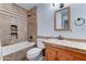 Cozy bathroom boasts a bath-shower combo, built-in wall shelves, and warm-toned vanity at 8220 E Montecito Ave, Scottsdale, AZ 85251