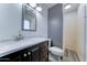 Modern bathroom featuring a gray accent wall, quartz countertop, new vanity, and updated shower at 8220 E Montecito Ave, Scottsdale, AZ 85251