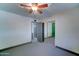 Standard bedroom with painted floors, mirrored closet doors and ceiling fan at 8220 E Montecito Ave, Scottsdale, AZ 85251