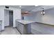 Kitchen features granite island with grey cabinetry and open access to living room at 8220 E Montecito Ave, Scottsdale, AZ 85251