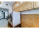 Convenient laundry room with front loading washer and dryer and lots of cabinet space for extra storage at 8220 E Montecito Ave, Scottsdale, AZ 85251