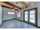 Bright living room features wood beam ceiling, ceiling fan, and view of backyard pool at 8220 E Montecito Ave, Scottsdale, AZ 85251