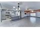 Open-concept living room and kitchen with stainless steel appliances at 8220 E Montecito Ave, Scottsdale, AZ 85251