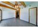 Bright living room features wood beam ceiling, ceiling fan, and wood trim entryway at 8220 E Montecito Ave, Scottsdale, AZ 85251