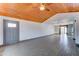 Open-concept living room featuring natural wood ceiling and wood-look tile flooring at 8220 E Montecito Ave, Scottsdale, AZ 85251