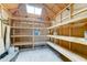 A spacious storage area is equipped with wooden support beams and shelves that have ample capacity at 8220 E Montecito Ave, Scottsdale, AZ 85251