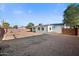 A large backyard featuring rock groundcover and a block fence at 8524 E Mariposa Dr, Scottsdale, AZ 85251