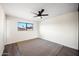 Comfortable bedroom offering a ceiling fan, plush carpet, and views of the neighborhood at 8524 E Mariposa Dr, Scottsdale, AZ 85251