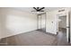 Spacious bedroom featuring mirrored closet doors, modern ceiling fan, plush carpet and new laminate flooring at 8524 E Mariposa Dr, Scottsdale, AZ 85251