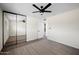 Inviting bedroom showcasing mirrored closet doors, modern ceiling fan, plush carpet and new laminate flooring at 8524 E Mariposa Dr, Scottsdale, AZ 85251