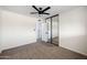 Comfortable bedroom offering ample closet space with mirrored doors, plush carpeting, and a modern ceiling fan at 8524 E Mariposa Dr, Scottsdale, AZ 85251