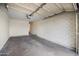 Spacious garage with concrete flooring and white brick walls at 8524 E Mariposa Dr, Scottsdale, AZ 85251