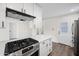 Bright kitchen features white cabinetry, stainless steel appliances, and quartz countertops, creating a modern cooking space at 8524 E Mariposa Dr, Scottsdale, AZ 85251