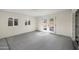 A bright living room featuring new flooring, fresh paint, and double doors to the backyard at 8524 E Mariposa Dr, Scottsdale, AZ 85251