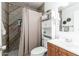 This bathroom features a vanity, toilet, and shower with a shower curtain at 8602 N 27Th Ave, Phoenix, AZ 85051