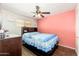 This bedroom features wood floors, a ceiling fan, and a full bed at 8602 N 27Th Ave, Phoenix, AZ 85051