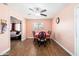 Cozy dining room with wood floors, ceiling fan, and view to living room at 8602 N 27Th Ave, Phoenix, AZ 85051