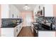 Modern kitchen with sleek black countertops, white cabinets, and stainless steel appliances at 8602 N 27Th Ave, Phoenix, AZ 85051