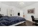 Comfortable bedroom with vaulted ceiling, a large bed, and access to an ensuite bathroom at 8840 E Sunland Ave # 137, Mesa, AZ 85208