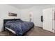 Cozy bedroom features a large bed, vaulted ceiling, and a view of the ensuite bathroom at 8840 E Sunland Ave # 137, Mesa, AZ 85208