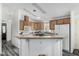 Spacious kitchen with wood cabinets, a breakfast bar, and modern appliances at 8840 E Sunland Ave # 137, Mesa, AZ 85208