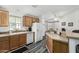 Bright kitchen features wood cabinets, neutral counters, and updated appliances with ample natural light at 8840 E Sunland Ave # 137, Mesa, AZ 85208