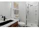 A well-lit bathroom with granite counters, a sleek sink, and a modern shower with a glass door at 9147 W Minnezona Ave, Phoenix, AZ 85037
