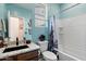 Nautical-themed bathroom with granite countertop, marine wall decor and blue shower curtain at 9147 W Minnezona Ave, Phoenix, AZ 85037
