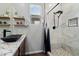 Modern bathroom featuring granite counters, contemporary fixtures, and a glass-enclosed shower at 9147 W Minnezona Ave, Phoenix, AZ 85037