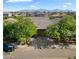 Aerial shot showcasing the house with a well-manicured front yard, complemented by a paved driveway and a mountain view at 9147 W Minnezona Ave, Phoenix, AZ 85037