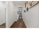 Bright hallway with decorative accents and dark wood floors at 9147 W Minnezona Ave, Phoenix, AZ 85037