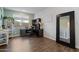 This home office includes a dark wood desk with drawers, a large mirror, and wood floors at 9147 W Minnezona Ave, Phoenix, AZ 85037
