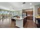 Spacious kitchen with granite countertops and open view to the living area and patio at 9147 W Minnezona Ave, Phoenix, AZ 85037