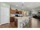 Bright open kitchen with barstool seating, granite countertops, and stainless appliances at 9147 W Minnezona Ave, Phoenix, AZ 85037