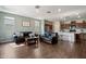A stylish living room with hardwood floors, a comfortable sofa, and an open layout to the kitchen at 9147 W Minnezona Ave, Phoenix, AZ 85037