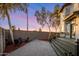 Beautiful backyard featuring a paved patio, lush landscaping, and an inviting outdoor seating area around a firepit at 942 S Ash Ave # 104, Tempe, AZ 85281