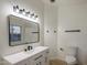 Bathroom featuring modern vanity with black hardware, an updated mirror, sink and toilet at 942 S Ash Ave # 104, Tempe, AZ 85281