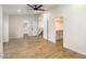 Spacious bedroom features light wood floors, a ceiling fan and convenient ensuite bathroom and walk-in closet at 942 S Ash Ave # 104, Tempe, AZ 85281