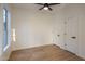 This bedroom has light wood floors, a ceiling fan and a window for natural light. It has neutral walls at 942 S Ash Ave # 104, Tempe, AZ 85281
