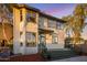 Charming two-story home with large windows, a porch and inviting entrance, complemented by lush landscaping at 942 S Ash Ave # 104, Tempe, AZ 85281