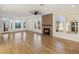 Sun-filled open-concept living room featuring modern fireplace, hardwood floors, and large windows at 942 S Ash Ave # 104, Tempe, AZ 85281