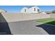 Picture of the backyard with a gray rock landscape and a green lawn at 9510 E Theia Dr, Mesa, AZ 85212