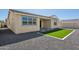 Exterior backyard view shows modern landscaping design with rocks and a green lawn at 9510 E Theia Dr, Mesa, AZ 85212