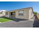 The backyard featuring rock landscaping, green lawn, and covered patio at 9510 E Theia Dr, Mesa, AZ 85212