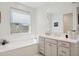 This bathroom features a soaking tub, vanity area, and a large window at 9510 E Theia Dr, Mesa, AZ 85212